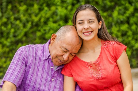 Close up of father sleeping his daughter shoulder at outdoors in the parkの写真素材