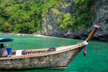 AO NANG, THAILAND - MARCH 23, 2018: Outdoor view of long tail boat in Thailand, standing on Chicken island in a gorgeous sunny day and turquoise waterのeditorial素材