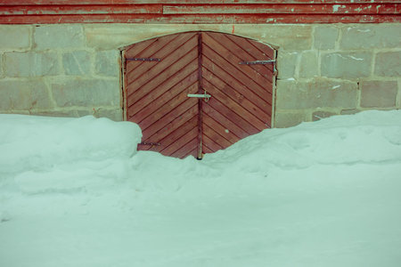 Close up of traditional Norwegian mountain wooden houses, door with snow in stunning nature in...