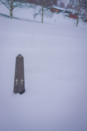 Outdoor view of stoned struture in the snow with two crosses during winter at Valdres region in Norwayの写真素材