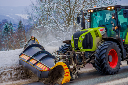 Valdres, Norway - March 26, 2018: Snow-removing machine cleans the street of the road from the snow in the morning snow-covered trees and roads in Norwayのeditorial素材