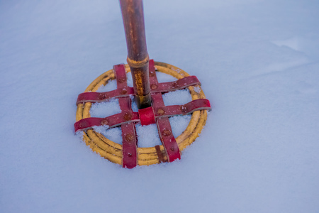 Close up of colorful pair of ski and hiking poles over the snow in Norwayの写真素材