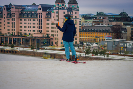 OSLO, NORWAY - MARCH, 26, 2018: Beautiful outdoor view of unidentified woman with skii clothes at Ski Jump building, located in Oslo, Norwayのeditorial素材