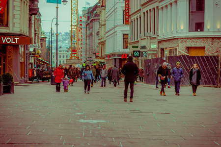 OSLO, NORWAY - MARCH, 26, 2018: Outdoor view of people walking in the streets of Oslo town, in Summer Late Eveningのeditorial素材