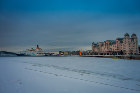OSLO, NORWAY - MARCH, 26, 2018: Outdoor view at Oslo city from the roof of Oslo Opera House. The pink building is Havnelageretのeditorial素材