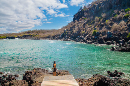 GALAPAGOS, ECUADOR, MARCH, 19 2018: Outdoor view of gorgeous young woman enjoying the landscape of Galapagos Islandsのeditorial素材