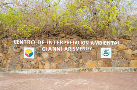 GALAPAGOS, ECUADOR, MARCH, 19 2018: Informative sign over a stoned wall of Gianni Arismendi, at path way across the mangrove on Isabela Island. Galapagos Islandsのeditorial素材