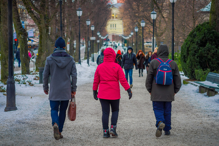 OSLO, NORWAY - MARCH 8, 2017: Outdoor view of people walking at vigeland Park, wearing warm clothes on a breezy winter dayのeditorial素材