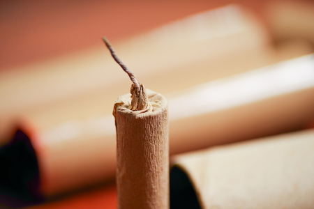 Close up of selective focus of wick of brown firecrackers in a blurred backgroundの写真素材