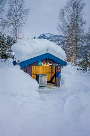 Reinli, Norway - March 26, 2018: Outdoor view of wooden garbage collector at outdoors under a wooden hut in Valdres region during winterのeditorial素材