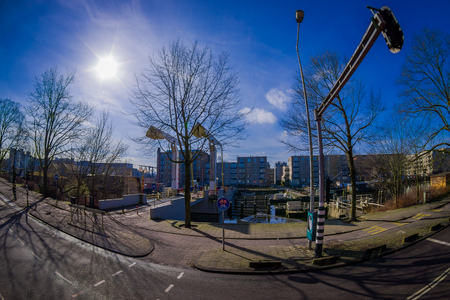 AMSTERDAM, NETHERLANDS, MARCH, 10 2018: Outdoor view of the streets close to the canals of Amsterdam, is the capital and most populous city of the Netherlands in beautiful sunny dayのeditorial素材