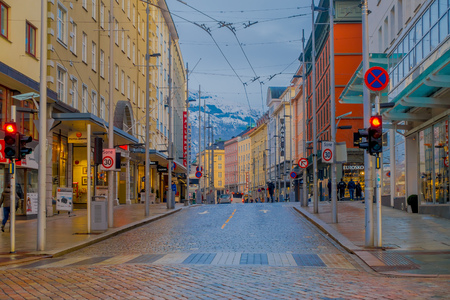 BERGEN, NORWAY - APRIL 03, 2018: Unidentified people walking in a quiet side street citys well-preserved 19th century architecture, on a typically cloudy dayのeditorial素材