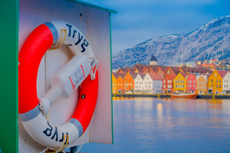 Bergen, Norway - April 03, 2018: Close up of a lifesaver with outdoor view of historical buildings behind in Bryggen- Hanseatic wharf in Bergen, Norway. UNESCO World Heritage Siteのeditorial素材