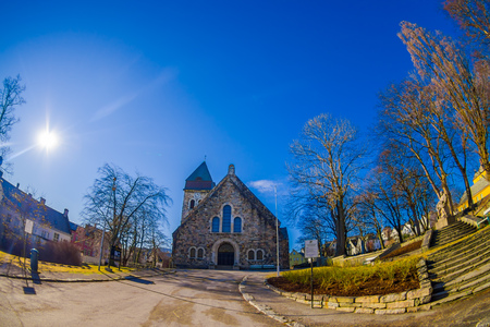 ALESUND, NORWAY - APRIL 04, 2018: Outdoor view of Alesund church, with a blue sky with sun shine in the sky on Kirkegataのeditorial素材