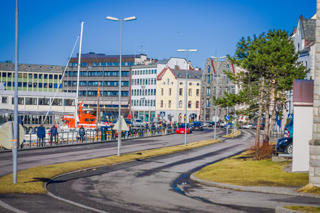 ALESUND, NORWAY - APRIL 04, 2018: Outdoor view of tourists walking in Alesund historic city center, Norwayのeditorial素材