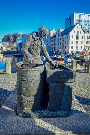 ALESUND, NORWAY - APRIL 04, 2018: Outdoor view of the herring woman statue in Alesund, Norway. Fishing especially herring industry historically was very important for Alesundのeditorial素材