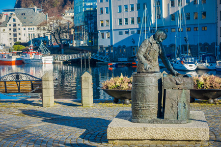 ALESUND, NORWAY - APRIL 04, 2018: Outdoor view of the herring woman statue in Alesund, Norway. Fishing especially herring industry historically was very important for Alesundのeditorial素材