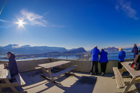 ALESUND, NORWAY - APRIL 04, 2018: Unidentified People enjoying the view and taking pictures from the birds eye view of Alesund port town on the west coast of Norwayのeditorial素材