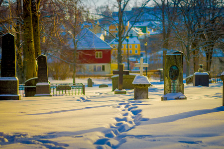 TRONDHEIM, NORWAY - APRIL 04, 2018: Gorgeous view of tombstones covered with snow during winter in Nidaros Cathedral Nidarosdomen in Trondheim, Norwayのeditorial素材