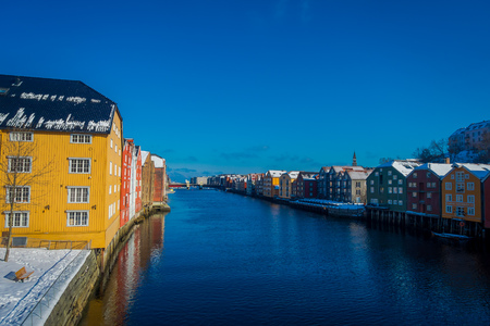 TRONDHEIM, NORWAY - APRIL 04, 2018: Gorgeous view of famous wooden colored houses from bridge in Trondheim city, Norwayのeditorial素材