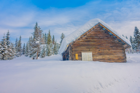 Bagnsasen, Norway - April, 02, 2018: Outdoor view with lonely wooden house covered with heavy snowのeditorial素材