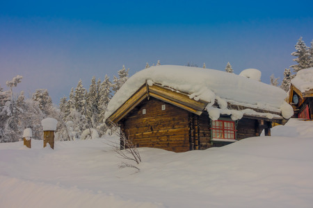 Bagnsasen, Norway - April, 02, 2018: Outdoor view with lonely wooden house covered with heavy snowのeditorial素材