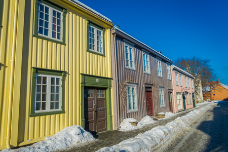 TRONDHEIM, NORWAY - APRIL 04, 2018: Outdoor view of Scandinavian wooden buildings stand along old street in Trondheim, Norwayのeditorial素材