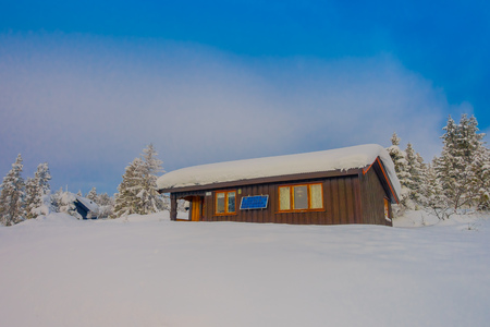 Bagnsasen, Norway - April, 02, 2018: Outdoor view of lonely wooden modern house covered with heavy snowのeditorial素材