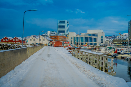Bodo, Norway - April 09, 2018: Outdoor view of the shore and marina area with some boats in a row in the water located in the port of Bodoのeditorial素材