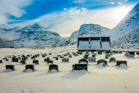 LOFOTEN, NORWAY, APRIL, 10, 2018: Outdoor view of snow-covered gravestones at Kabelvag cemetery on Lofoten Islands, Nordlandのeditorial素材