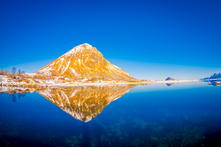 Scenic view of fjord with yellow mountain peaks and reflection in water on Lofoten islands in Norway, Scandinavia, Europeの写真素材