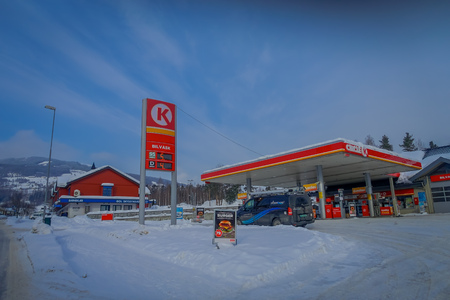 GOL, NORWAY, APRIL, 02, 2018: Outdoor view of some cars in a gas station, covered with snow in GOLのeditorial素材