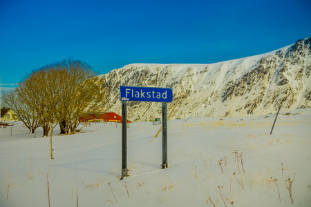 LOFOTEN, NORWAY, APRIL, 10, 2018: Outdoor view of informative sign in metallic structure located in the snow with huge mountains behind in lofoten islandのeditorial素材