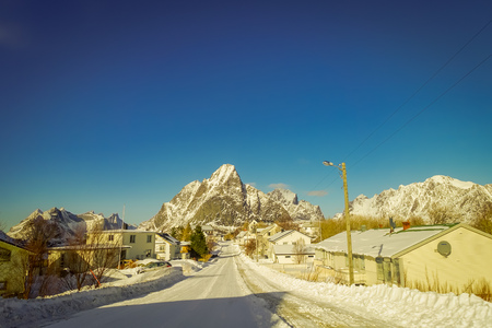 LOFOTEN, NORWAY, APRIL, 10, 2018: Outdoor view of frozen street with some buildings in every side of the road in Skjelfjord Lofoten Islandsのeditorial素材