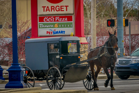 LANCASTER, USA - APRIL, 18, 2018: View of amish carriage along the city, known for simple living with touch of nature contacy, plain dress, and reluctance to adopt conveniences of modern technologyのeditorial素材