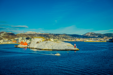 Bodo, Norway - April 09, 2018: Outdoor view of landscape of a lighthouse at Bodos coast and some buildings, with a gorgeous blue sky in Norwayのeditorial素材
