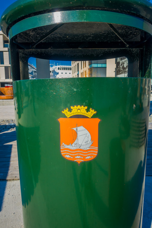 ALESUND, NORWAY - APRIL 04, 2018: Close up of a stamp over a green metallic garbage collector located in the streets of Alesund town on the west coast of Norwayのeditorial素材