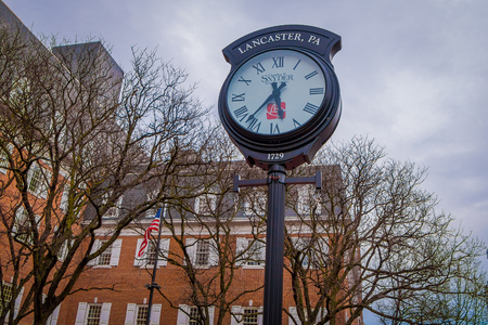 LANCASTER, USA - APRIL, 18, 2018: Outdoor view of huge metallic clock located in downtown Lancaster, Pennsylvania in a cloudy dayのeditorial素材