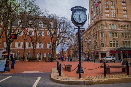 LANCASTER, USA - APRIL, 18, 2018: Outdoor view of huge metallic clock located in downtown Lancaster, Pennsylvania in a cloudy dayのeditorial素材