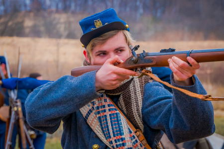 MOORPARK, USA - APRIL, 18, 2018: Portrait of handsome boy holding a gun in his hands ready to shoot representing the civil War Reenactment in Moorpark, the largest battle reenactmentのeditorial素材