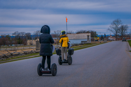 GETTYSBURG, USA - APRIL, 18, 2018: Back view line of tourists on Segways Seg Tours in Gettysburg National Military Park, in a tour on Cemetery battlefield parkのeditorial素材