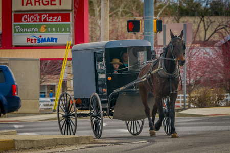 LANCASTER, USA - APRIL, 18, 2018: View of amish carriage along the city, known for simple living with touch of nature contacy, plain dress, and reluctance to adopt conveniences of modern technologyのeditorial素材