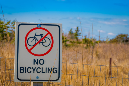 LONG ISLAND, USA, APRIL, 17, 2018: Outdoor view of informative sign of no bicycling area in metallic structure, located at outdoors of the beach at Long islandのeditorial素材