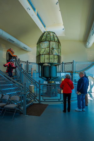 CLONG ISLAND, USA, APRIL, 14, 2018: Indoor view of unidentified people enjoying the exposure of huge Lamp inside the Montauk Point Lighthouse at the edge of Long Island, New Yorkのeditorial素材