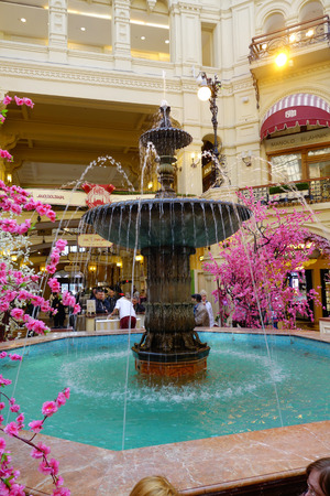 MOSCOS, RUSSIA- APRIL, 24, 2018: Unidentified people walking close yo a fountain inside the main store on the Red Squareのeditorial素材