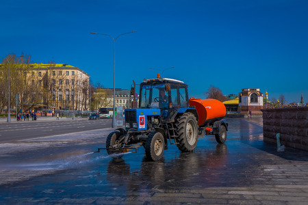 MOSCOW, RUSSIA- APRIL, 24, 2018: Outdoor view of man driving a cleaning machine washing the pavement with water after event in the streets of Moscowのeditorial素材