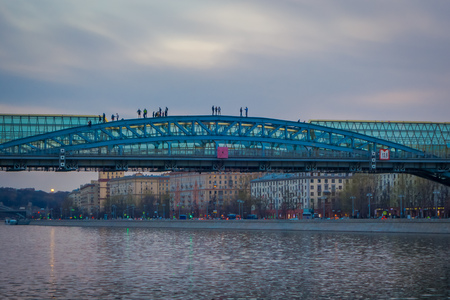 MOSCOW, RUSSIA- APRIL, 24, 2018: Andreevsky Bridge for pedestrians which leads to Gorky park. The Moscow river embankment, city center popular place for walking in sunset viewのeditorial素材