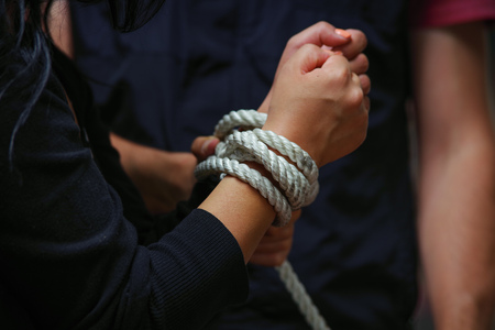 Close up of kidnapped woman tied with rope - abuse and violence conceptの写真素材