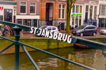 AMSTERDAM, NETHERLANDS, APRIL, 23 2018: Close up of metallic structure with carved word of St. Jansbrug in the canal of Amsterdam, is the capital and most populous city of the Netherlandsのeditorial素材