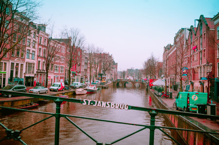 AMSTERDAM, NETHERLANDS, APRIL, 23 2018: Beautiful outdoor view of the canal of Amsterdam dring a rainny day, is the capital and most populous city of the Netherlandsのeditorial素材